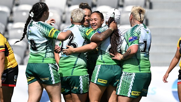Cook Islands players celebrate a try against Papua New Guinea during the Pacific Championships.
