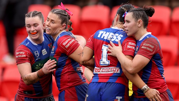 The Newcastle Knights celebrate a try against the Canberra Raiders. 