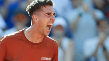 Australia's Thanasi Kokkinakis celebrates after winning his second round match of the French Open tennis tournament against Switzerland's Stan Wawrinka.