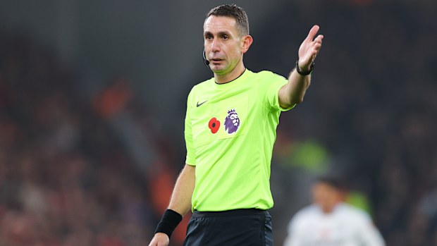 Referee David Coote gestures during a Premier League match in 2024.