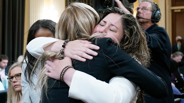 Sandra Garza, the long-time partner of fallen Capitol Police Officer Brian Sicknick, right, hugs US Capitol Police officer Caroline Edwards.
