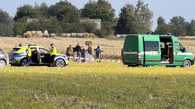 Police and Military Police secure parts of a damaged UAV shot down by Polish authorities  at a site in Wohyn, Poland.
