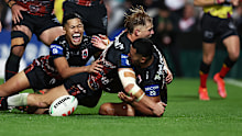 Jack de Belin jumps on Mathew Feagai as the Dragons celebrate the match winning try against the Roosters.