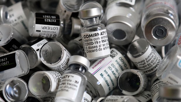 In this file photo dated Saturday, May 15, 2021, empty vials of the Pfizer-BioNTech COVID-19 vaccine lie in a box during a vaccine campaign in Ebersberg near Munich, Germany. (AP Photo/Matthias Schrader, FILE)