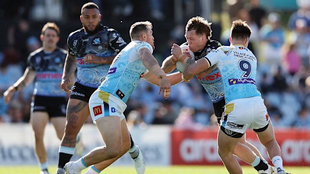 Cameron McInnes of the Sharks is tackled.