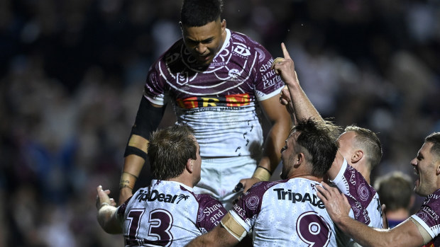 Manly players celebrate Jake Trbojevic's second half try against the Storm.