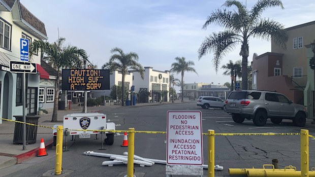 A street is closed due to high surf conditions near Capitola Beach, Monday, Dec. 23, 2024, in Capitola, Calif. (AP Photo/Pamela Hassell)