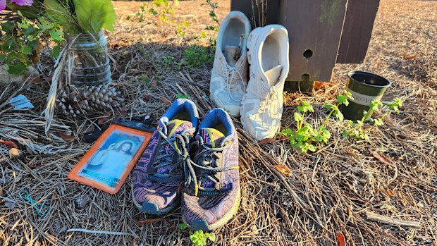 Mourners placed running shoes at a memorial near the site of Laken Riley's killing in Athens, Georgia.
