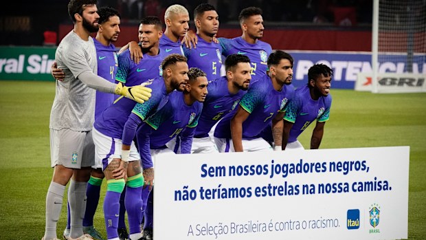 Brazil players pose with an anti-racism banner.
