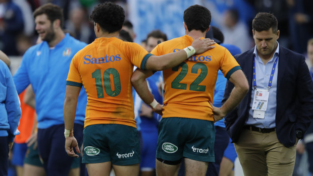 Noah Lolesio of Australia consoles Ben Donaldson after losing to Italy in 2022.