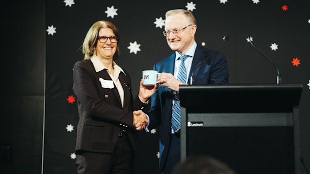 Newly appointed Governor Michele Bullock receiving a mug from Philip Lowe