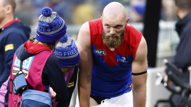 Melbourne's Max Gawn comes to the bench injured.