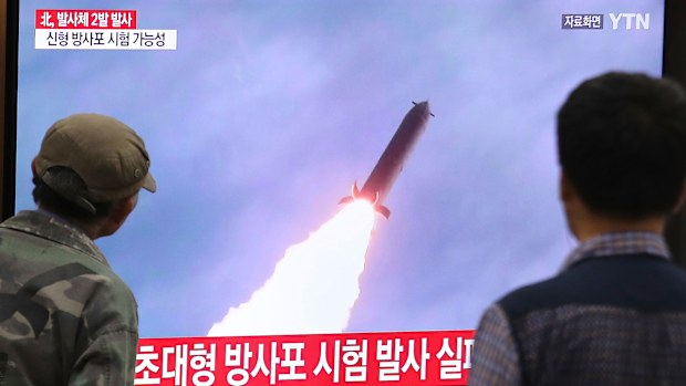 People watch a TV showing a file image of an unspecified North Korea's missile launch (not today's launch) during a news program at the Seoul Railway Station in Seoul, South Korea.
