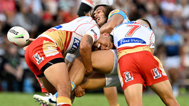 Tino Fa'asuamaleaui of the Titans offloads during the NRL Trial Match between the Dolphins and the Gold Coast Titans at Kayo Stadium on February 19, 2023 in Brisbane, Australia. (Photo by Bradley Kanaris/Getty Images)