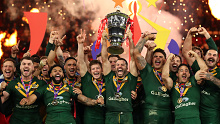 Kangaroos captain James Tedesco lifts the Rugby League World Cup trophy after Australia's win over Samoa in the 2022 tournament final.