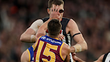 The eyewear of Mason Cox is knocked off his head by Dayne Zorko of the Lions.