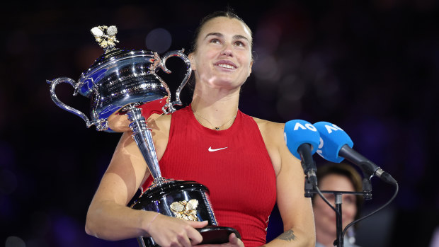 MELBOURNE, AUSTRALIA - JANUARY 27: Aryna Sabalenka holds the Daphne Akhurst Memorial Cup during the official presentation after the the Women's Singles Final match between Qinwen Zheng of China and Aryna Sabalenka during the 2024 Australian Open at Melbourne Park on January 27, 2024 in Melbourne, Australia. (Photo by Cameron Spencer/Getty Images)
