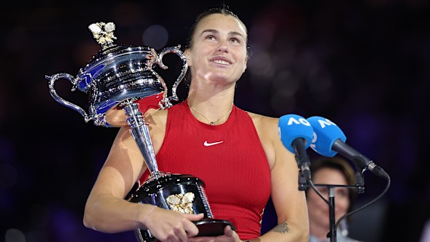 MELBOURNE, AUSTRALIA - JANUARY 27: Aryna Sabalenka holds the Daphne Akhurst Memorial Cup during the official presentation after the the Women's Singles Final match between Qinwen Zheng of China and Aryna Sabalenka during the 2024 Australian Open at Melbourne Park on January 27, 2024 in Melbourne, Australia. (Photo by Cameron Spencer/Getty Images)