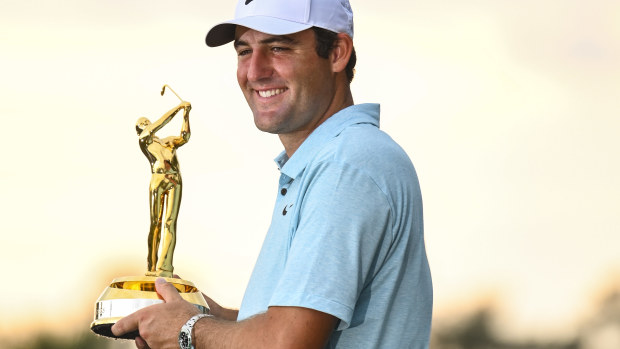 Scottie Scheffler smiles with the tournament trophy after his five stroke victory in the final round of THE PLAYERS Championship on the Stadium Course at TPC Sawgrass on March 12, 2023 in Ponte Vedra Beach, Florida. (Photo by Keyur KhamarPGA TOUR via Getty Images)