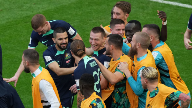 Mitchell Duke (C) of Australia celebrates with his teammates after scoring the opening goal against Tunisia in their Group D FIFA World Cup match at Qatar 2022.