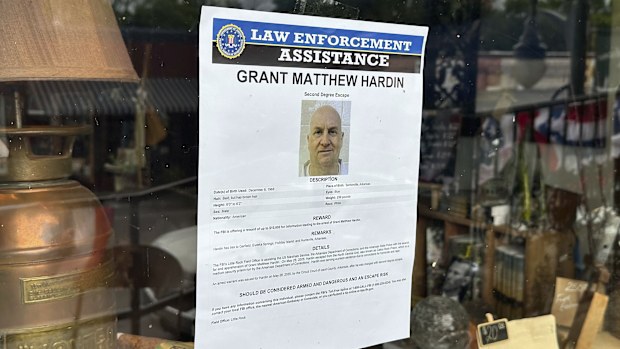 A flier looking for Grant Hardin hangs on the glass of a business, Thursday, May 29, 2025, in downtown Calico Rockt, Ark. (AP Photo/Nicholas Ingram)