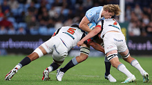 Ned Hanigan of the Waratahs is challenged by Tupou Vaa'i and Kaylum Boshier of the Chiefs