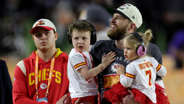 Harrison Butker of the Kansas City Chiefs celebrates with his children.