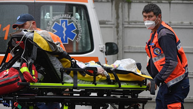 Paramedics bring an elderly patient to the emergency room, turned into a CODIV-19 unit due the high number of cases, at the Bagdasar-Arseni hospital in Bucharest, Romania, Tuesday, Oct. 12, 2021. Romania reported on Tuesday nearly 17,000 new COVID-19 infections and 442 deaths, the highest number of coronavirus infections and deaths in a day since the pandemic started, as the nation's health care system struggles to cope with an acute surge of new cases.(AP Photo/Andreea Alexandru)