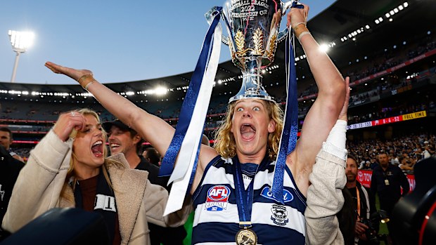 Sam De Koning of the Cats hold aloft the premiership cup after winning the 2022 AFL Grand Final match between the Geelong Cats and the Sydney Swans at the Melbourne Cricket Ground on September 24, 2022 in Melbourne, Australia. (Photo by Daniel Pockett/AFL Photos/via Getty Images)