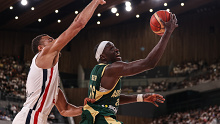 TOKYO, JAPAN - AUGUST 20: Duop Reath of Australia #26 of drives to the basket against Rudy Gobert #27 of France during the international basketball game between France and Australia at Ariake Arena on August 20, 2023 in Tokyo, Japan. (Photo by Takashi Aoyama/Getty Images)