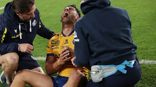 Bailey Simonsson of the Eels leaves the field injured after being on the wrong end of an amazing tackle by Dylan Edwards.