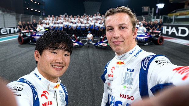 Yuki Tsunoda of Japan and Visa Cash App RB and Liam Lawson of New Zealand and Visa Cash App RB take a selfie at the Visa Cash App RB team photo after practice ahead of the F1 Grand Prix of Abu Dhabi at Yas Marina Circuit on December 06, 2024 in Abu Dhabi, United Arab Emirates. (Photo by Rudy Carezzevoli/Getty Images)