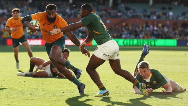 Marika Koroibete of the Wallabies makes a break to score a try.