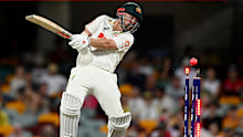 Travis Head is bowled by the pink ball at the Gabba. 