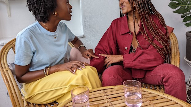 Female friends talking at a table.
