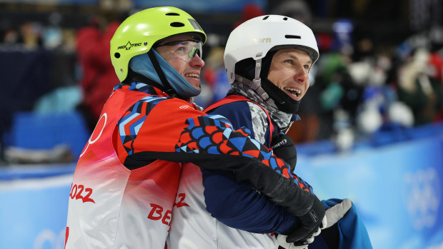 Bronze medallist Ilia Burov of Team ROC (L) and Silver medallist Oleksandr Abramenko of Team Ukraine (R) embrace during the men's freestyle skiing aerials final.