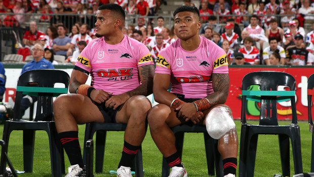 Injured Panther Brian To'o (R) looks on from the bench.