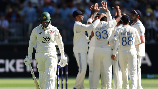 Usman Khawaja walks off the field after being dismissed by Jasprit Bumrah during the first Test.