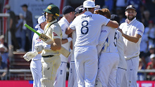 Australia's Marnus Labuschagne reacts as England players celebrate his dismissal.