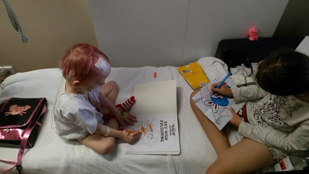 Broly Blackmore colours in with big sister Trinity in hospital.