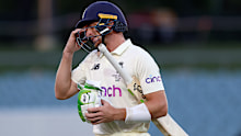 England's Jos Buttler leaves the field after being dismissed.