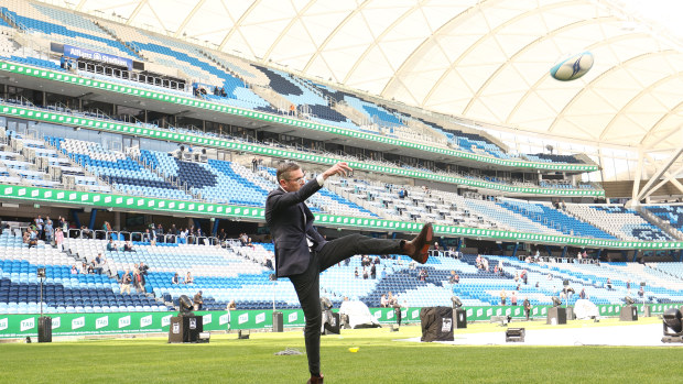 NSW Premier Dominic Perrottet kicks a rugby ball at Allianz Stadium.