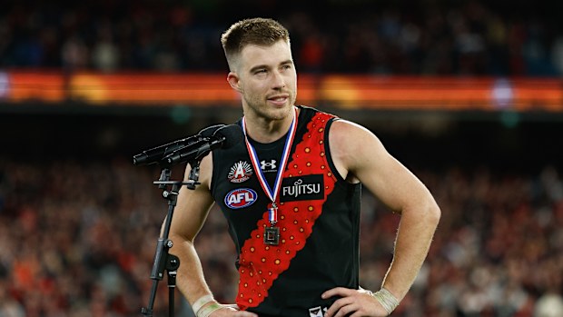 Zach Merrett of the Bombers receives the Anzac Day Medal.