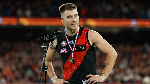 Zach Merrett of the Bombers receives the Anzac Day Medal.
