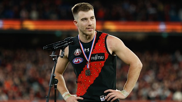 Zach Merrett of the Bombers receives the Anzac Day Medal.