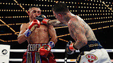 NEW YORK, NEW YORK - NOVEMBER 27:  George Kambosos punches Teofimo Lopez during their championship bout for Lopezs Undisputed Lightweight title at The Hulu Theater at Madison Square Garden on November 27, 2021 in New York, New York. (Photo by Al Bello/Getty Images)