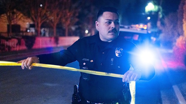 A police officer blocks off a street near Rob Reiner's residence Sunday, Dec. 14, 2025, in the Brentwood section of Los Angeles. (AP Photo/Ethan Swope)