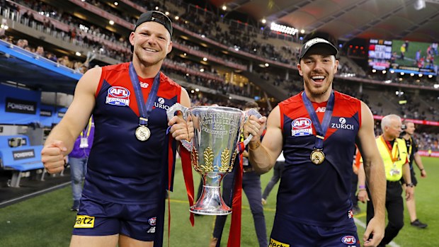 PERTH, AUSTRALIA - SEPTEMBER 25: Steven May of the Demons and Michael Hibberd of the Demons celebrate with the premiership cup during the 2021 Toyota AFL Grand Final match between the Melbourne Demons and the Western Bulldogs at Optus Stadium on September 25, 2021 in Perth, Australia. (Photo by Dylan Burns/AFL Photos)