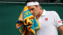 Switzerland's Roger Federer wipes his face with a towel during the men's singles quarterfinals match against Poland's Hubert Hurkacz on day nine of the Wimbledon Tennis Championships in London, Wednesday, July 7, 2021. (AP Photo/Kirsty Wigglesworth)