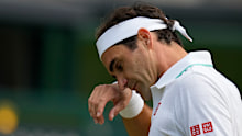 Switzerland's Roger Federer wipes his brow during the men's singles quarterfinals match against Poland's Hubert Hurkacz on day nine of the Wimbledon Tennis Championships in London, Wednesday, July 7, 2021. (AP Photo/Kirsty Wigglesworth)